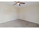 A comfortable bedroom with neutral walls, carpet flooring, and a ceiling fan at 792 Lehigh Rd, Venice, FL 34293