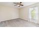 Bright bedroom features neutral walls, carpet flooring, and a ceiling fan at 792 Lehigh Rd, Venice, FL 34293