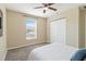 Bedroom with double door closet, window, and carpet flooring at 792 Lehigh Rd, Venice, FL 34293