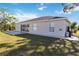 Rear view of house with patio and grassy yard at 792 Lehigh Rd, Venice, FL 34293