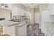 Kitchen features white cabinets, granite counters and a breakfast bar at 792 Lehigh Rd, Venice, FL 34293
