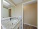 Bright bathroom with granite countertop, updated vanity, and large mirror at 907 Jarvis Ter, Port Charlotte, FL 33948