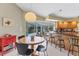 Eat-in kitchen area with a round table, bar counter seating, and pool view at 9131 Berendo Ave, Englewood, FL 34224