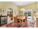 Dining room with sliding glass doors leading to a screened-in pool area at 9131 Berendo Ave, Englewood, FL 34224