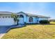 Charming front yard with manicured landscaping and decorative palm trees at 9131 Berendo Ave, Englewood, FL 34224