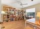 Home office or study with wood floors, built-in shelving, and desk at 9131 Berendo Ave, Englewood, FL 34224