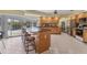 Kitchen with ample wood cabinetry, stainless steel appliances, and large center island at 9131 Berendo Ave, Englewood, FL 34224