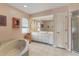 Main bathroom with double vanity, large soaking tub, and separate shower at 9131 Berendo Ave, Englewood, FL 34224