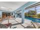 Screened-in pool with a blue patio and lounge chairs at 9131 Berendo Ave, Englewood, FL 34224