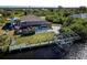 An aerial view showcasing a home with a pool, boat dock, and lush tropical surroundings at 9300 Miami Cir, Port Charlotte, FL 33981