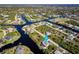 High-altitude aerial view showcasing the home's location within a waterfront community at 9300 Miami Cir, Port Charlotte, FL 33981