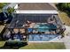 Aerial view of the property showcasing pool, patio, and landscaping at 9300 Miami Cir, Port Charlotte, FL 33981