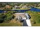 Aerial view of home with waterfront access, pool, and boat storage at 9300 Miami Cir, Port Charlotte, FL 33981