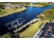 Top-down view of a backyard with pool, dock, and boat lift at 9300 Miami Cir, Port Charlotte, FL 33981