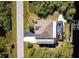 Aerial view of a home with a pool, dock, and lush landscaping at 9300 Miami Cir, Port Charlotte, FL 33981