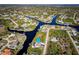 Aerial view of canal-front properties and surrounding neighborhood at 9300 Miami Cir, Port Charlotte, FL 33981