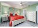 Bedroom with white bed, matching dresser, and green walls at 9300 Miami Cir, Port Charlotte, FL 33981