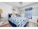 Blue and white bedroom with fish and nautical-themed decor and ceiling fan at 9300 Miami Cir, Port Charlotte, FL 33981