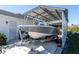 Covered carport protecting a boat on a trailer at 9300 Miami Cir, Port Charlotte, FL 33981
