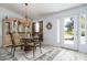Bright dining room with glass-top table and view of backyard through glass door at 9300 Miami Cir, Port Charlotte, FL 33981