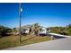 Charming home exterior with palm tree and landscaped front yard at 9300 Miami Cir, Port Charlotte, FL 33981