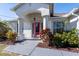 Front exterior of home with pink door, arched entryway, and landscaped yard at 9300 Miami Cir, Port Charlotte, FL 33981