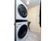 Laundry room with modern, stacked washer and dryer at 9300 Miami Cir, Port Charlotte, FL 33981