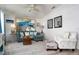 Inviting living room with comfortable seating, coastal decor, and wood-look flooring at 9300 Miami Cir, Port Charlotte, FL 33981