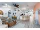 Living room with wicker furniture, coastal decor, and view of the kitchen and breakfast bar at 9300 Miami Cir, Port Charlotte, FL 33981