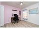 Office/den with wooden desk, chair, map wall hanging, and pink accent wall at 9300 Miami Cir, Port Charlotte, FL 33981