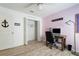 Office/den with pink walls, closet with wire shelving, and coastal-style decor at 9300 Miami Cir, Port Charlotte, FL 33981