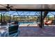 Spacious pool area with covered patio and outdoor dining furniture at 9300 Miami Cir, Port Charlotte, FL 33981