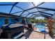 Spacious pool area with a hot tub, lounge chairs, and lush landscaping at 9300 Miami Cir, Port Charlotte, FL 33981