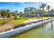 Waterfront property showcasing expansive yard and seawall at 99 W Riverview Ave, Englewood, FL 34223