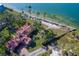 Aerial view of waterfront home with expansive lot and mature trees at 99 W Riverview Ave, Englewood, FL 34223
