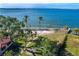 Aerial view of waterfront property with mature trees and a home at 99 W Riverview Ave, Englewood, FL 34223
