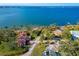 Aerial view showcasing waterfront homes and lush landscaping at 99 W Riverview Ave, Englewood, FL 34223