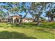 Large backyard with mature trees providing shade and privacy at 99 W Riverview Ave, Englewood, FL 34223