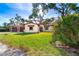 House exterior showcasing lush landscaping and a welcoming facade at 99 W Riverview Ave, Englewood, FL 34223