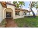 View of home's side entrance and surrounding landscape at 99 W Riverview Ave, Englewood, FL 34223