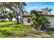 Side view showcasing the home's architectural details and landscaping at 99 W Riverview Ave, Englewood, FL 34223