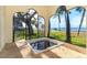 Sunroom with hot tub and waterfront views at 99 W Riverview Ave, Englewood, FL 34223