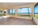 Sunroom with large windows and water views at 99 W Riverview Ave, Englewood, FL 34223