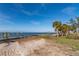 Peaceful waterfront lot with palm trees and calm water views at 99 W Riverview Ave, Englewood, FL 34223