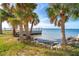 Waterfront view with palm trees and calm water views at 99 W Riverview Ave, Englewood, FL 34223