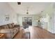 Living room with wood-look floors, a sofa, and access to patio at 10191 Rafferty Ave, Englewood, FL 34224