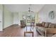 Living room with wood-look floors, and comfortable seating at 10191 Rafferty Ave, Englewood, FL 34224