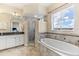 Bathroom with soaking tub, shower, granite vanity, and large mirror at 10300 Coral Landings Ct # 91, Placida, FL 33946