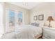 Bedroom with queen bed, private balcony access, and neutral decor at 10300 Coral Landings Ct # 91, Placida, FL 33946