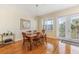 Charming dining room with wooden table and chairs, hardwood floors and access to balcony at 10300 Coral Landings Ct # 91, Placida, FL 33946